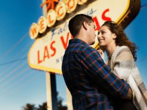 This is a picture of a couple by a Las Vegas sign that represents our list of cool and crazy things to do in Las Vegas