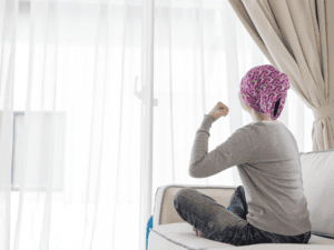 A picture of a woman sitting on a couch after receiving an oncology massage