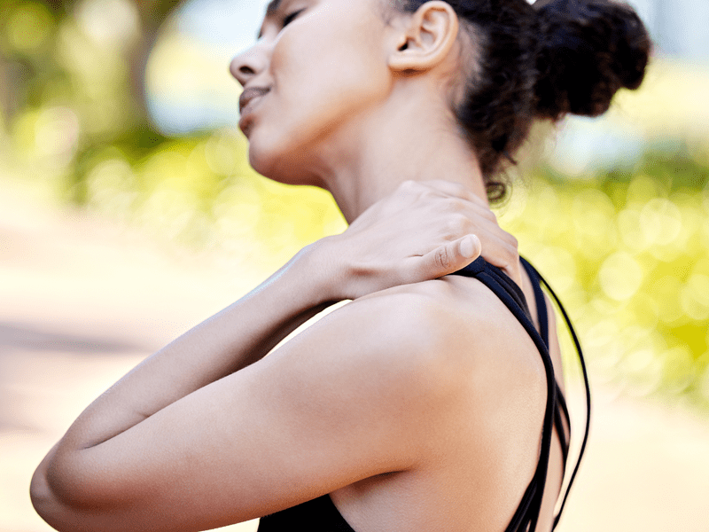 A woman experiencing pain in her neck from fibromyalgia