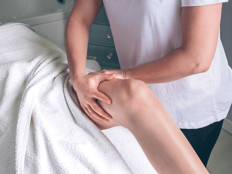 An image capturing a woman receiving a lymphatic massage on her leg in Las Vegas