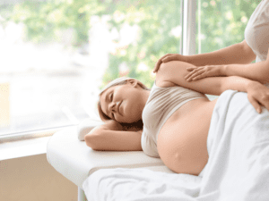 A woman receiving the best prenatal massage in Los Angeles at her home