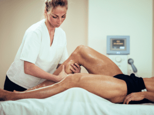 A man receiving a sports massage at his home in Las Vegas from a sports massage therapist
