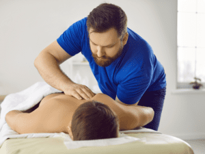 A man receiving a massage in Las Vegas from a male massage therapist at his home