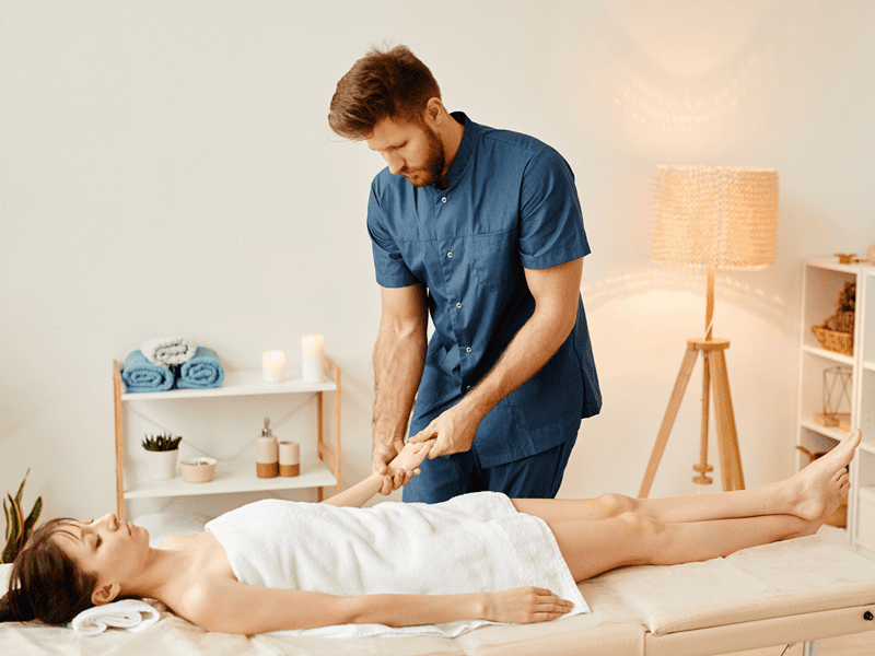A male massage therapist giving a woman a massage at her home in Las Vegas