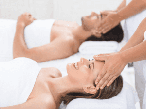 A couple enjoying a couples massage in Las Vegas in their hotel room from two male massage therapists