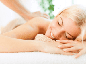 A woman enjoying a Swedish massage at home