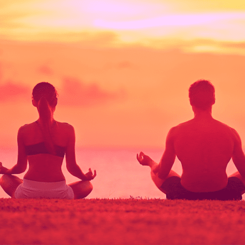 A couple from Las Vegas meditating on Venice Beach after getting a mobile massage at their beach front hotel room in Los Angeles