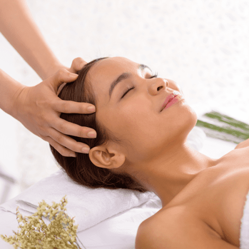 A picture of a woman receiving a head massage as an alternative treatment for cancer