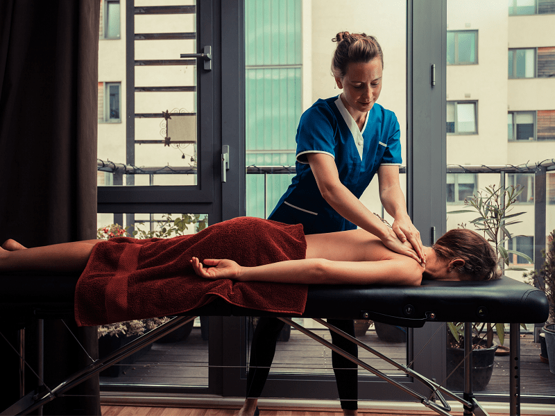 A woman enjoying a mobile massage at her home in Long Beach