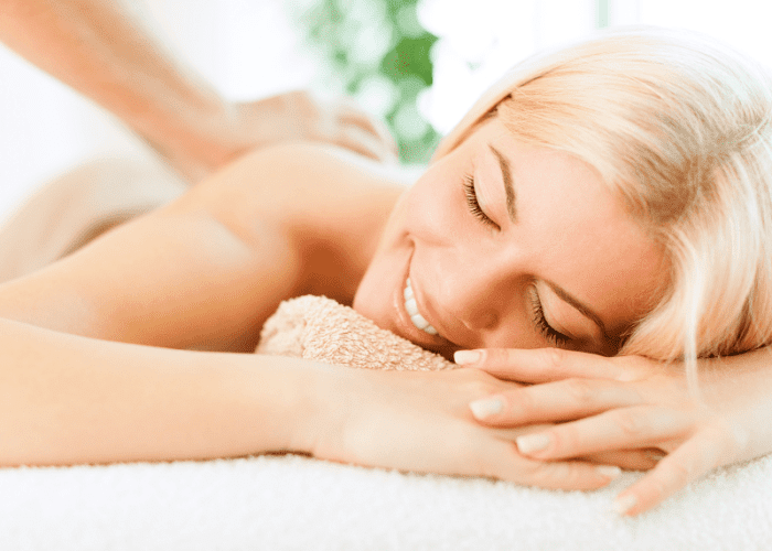 A woman getting a massage in Glendale, CA in her hotel room