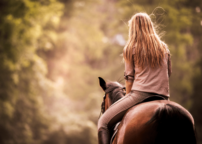 A picture of a woman horseback riding in Las Vegas