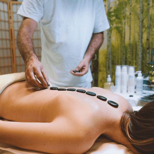 A woman getting a hot stones massage in Las Vegas at home