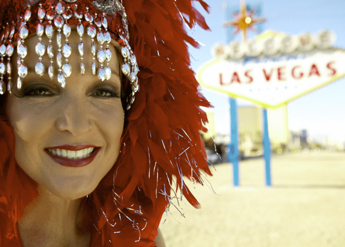 A Las Vegas Showgirl by a Las Vegas sign