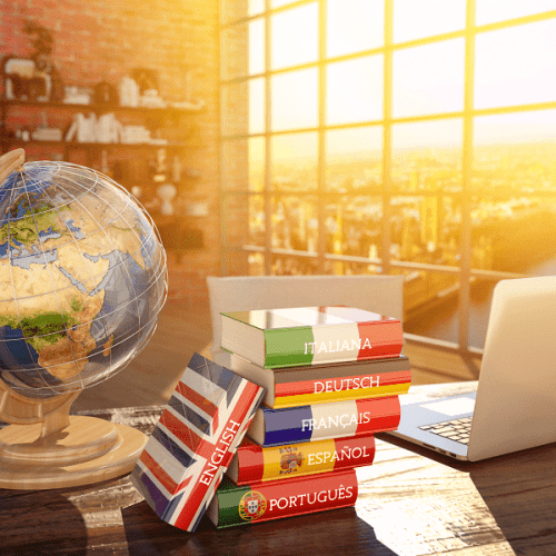 A picture of a traveling massage therapist's desk with a globe and various language learning books on it.