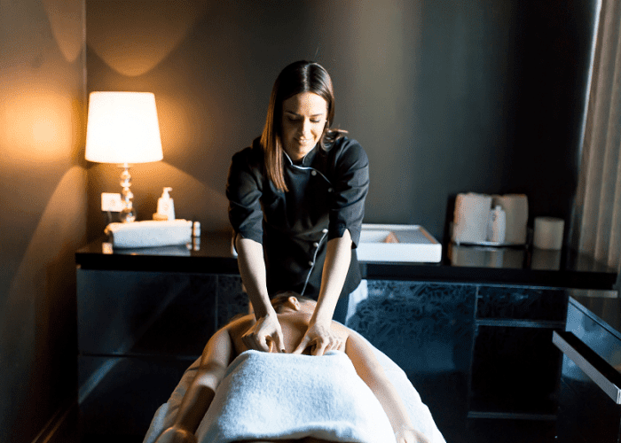 A woman getting a massage in Culver City in her hotel room