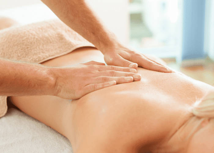 A woman getting a massage in Glendale, CA in her hotel room