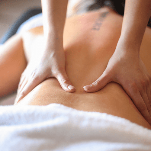 A woman with fibromyalgia receiving a massage in her home