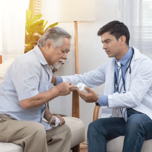 A picture of a man consulting with a doctor before booking a oncology massage for a family member