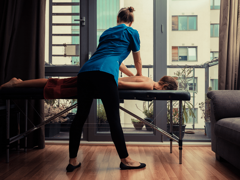 A woman getting an in-room massage in Las Vegas from a female massage therapist